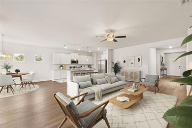 Living room with hardwood / wood-style flooring an