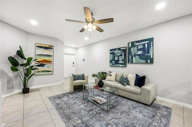 Living area with a ceiling fan, recessed lighting,