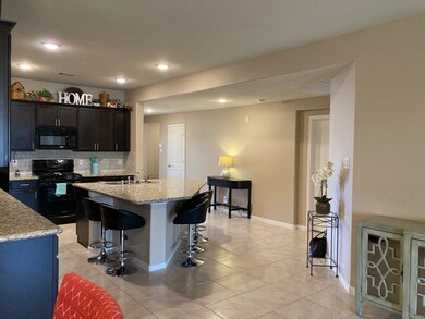 THE KITCHEN AND FOYER FEATURES 18 INCH TILE