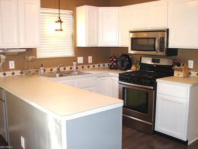 open kitchen with newer stainless appliances
