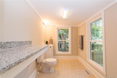 Half Bath off laundry room with Granite folding ta