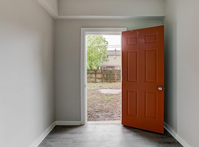 Entryway with wood finished floors and baseboards