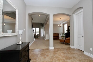 Inviting Tiled Foyer features gracious archways.