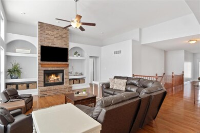 Great room with woodburning fireplace & built in bookcases