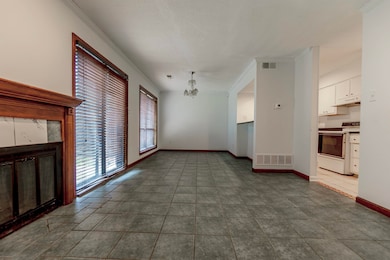 Unfurnished living room featuring tile patterned floors