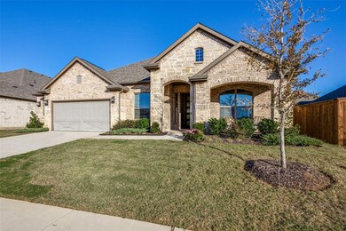 French country style house with a front yard and a garage