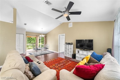 Living area featuring vaulted ceiling, a ceiling f
