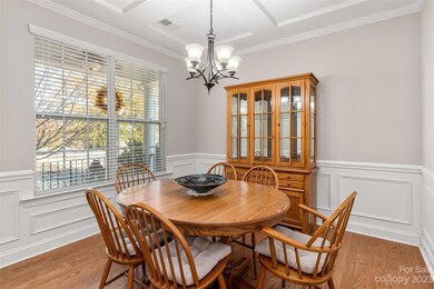 Dining Area With Coffered Ceiling and Extra Crown Molding