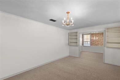 Carpeted empty room with ornamental molding and an