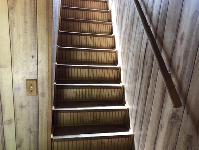 Staircase on right side of building when entering.