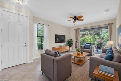 Living room with ceiling fan, light tile patterned