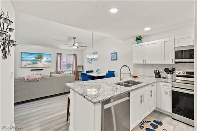 Kitchen featuring white cabinets, kitchen peninsul