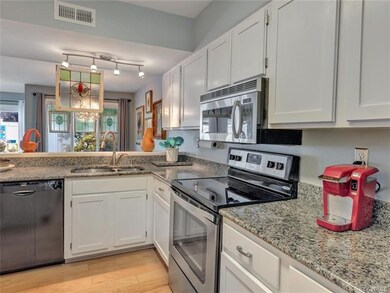 Updated kitchen with stainless appliances, granite