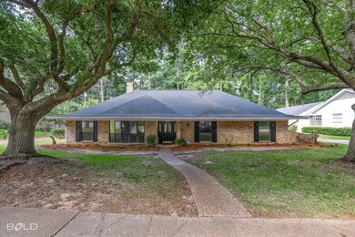 Ranch-style home featuring a front yard and covere