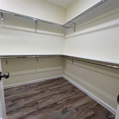 Walk in closet featuring dark wood finished floors