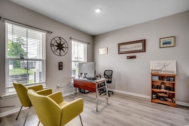 Office with baseboards and light wood-type flooring