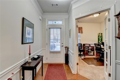 Entryway featuring light wood-style flooring, a de