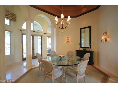 Formal dining room with view of lanai, lake, golf 