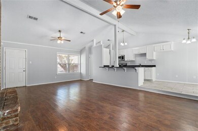 Unfurnished living room with lofted ceiling with b
