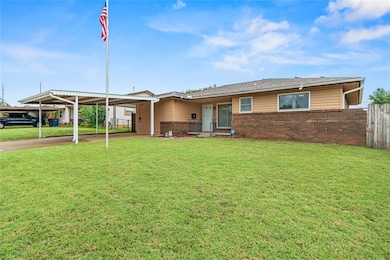 Single story home with brick siding and an attached carport