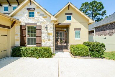 Stone, stucco, and brick elevation with gated courtyard entrance reminiscent of a beautiful Tuscan villa.