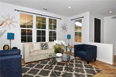 Welcome home! Entryway on right of picture, this living area is light and bright with large windows and recessed lighting!
