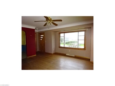 Living room has hardwood flooring, picture window 