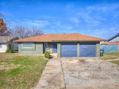 Single story home featuring a front yard and a gar