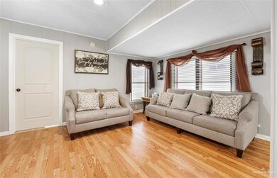 Living room with light hardwood / wood-style flooring and crown molding