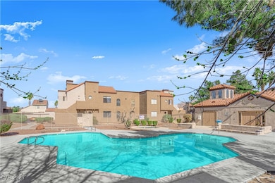 Pool featuring a residential view, fence, and an o