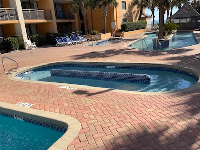 View of pool with a community hot tub and a patio 