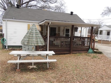 Wood deck with roof and two sets of stairs.