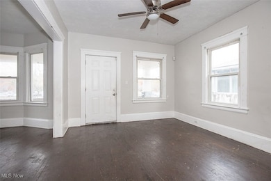 Foyer featuring dark wood-style flooring, a textured ceiling, and a ceiling fan