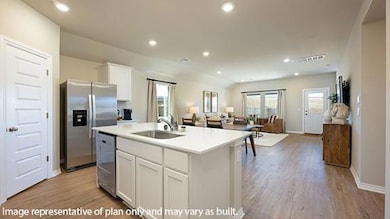 Kitchen with white cabinetry, open floor plan, recessed lighting, appliances with stainless steel finishes, and light wood-type flooring