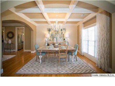 Formal dining room with coffered ceilings.