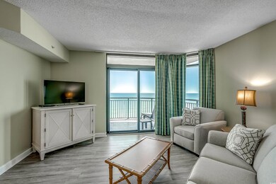 Living area featuring baseboards, a textured ceili