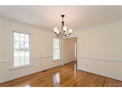 Bright dining room with pretty hardwood floors, ch