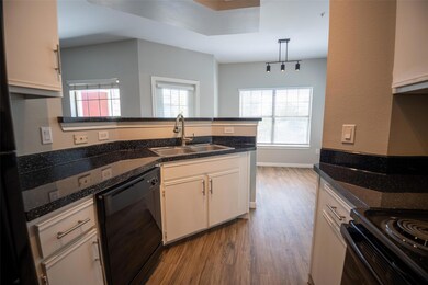 Kitchen featuring black appliances, a peninsula, 