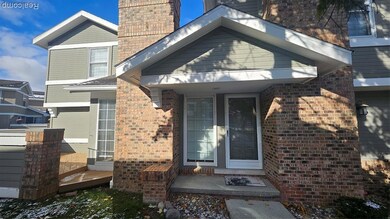Entrance to property with brick siding and a chimney