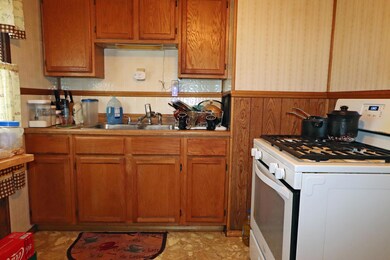 Kitchen with gas range, door to yard