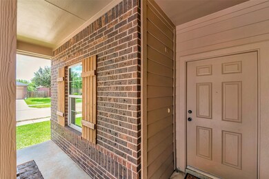 Welcoming covered front porch with decorative wood