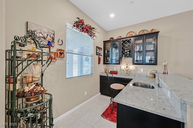 Bar area in kitchen featuring light tile patterned