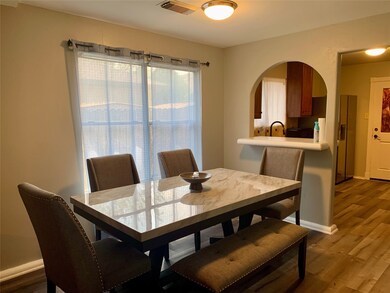 View of large windows that allow natural light into the living/dining area.