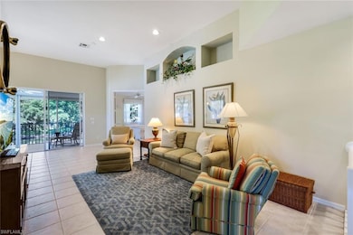 Tiled living room featuring recessed lighting, vis