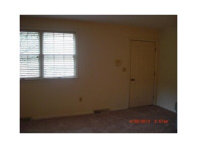 Living Room. door opens from a common foyer in bld