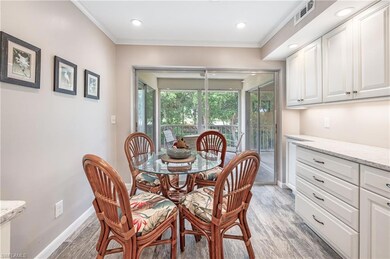 Dining space featuring light wood-style floors, ornamental molding, and recessed lighting