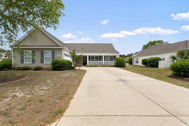 View of front of property with driveway, a garage,
