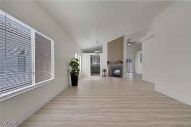 Unfurnished living room featuring a tiled fireplac