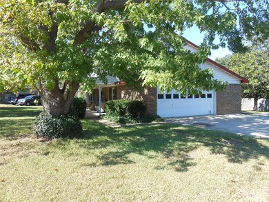 Obstructed view of property with a garage and a fr