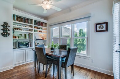 Beautiful breakfast room with built-in shelving and storage area overlooks the private yard.  
